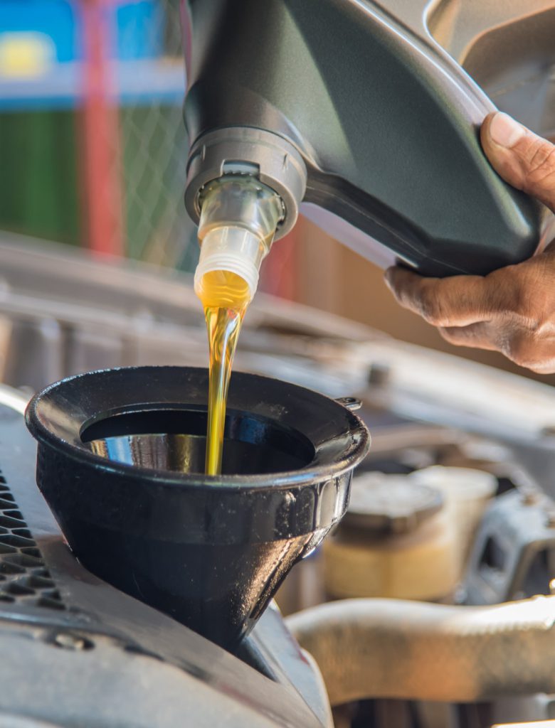 Mechanic pouring engine oil into a vehicle - Car Servicing Rotherham